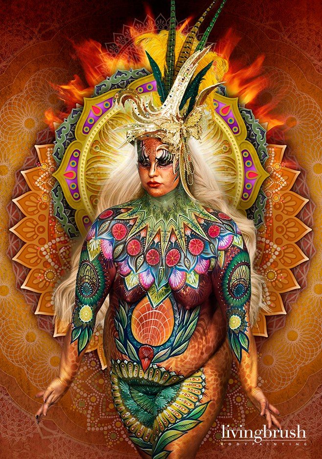 Bodypainting in gold, green and red, finished with a radiant sunburst background